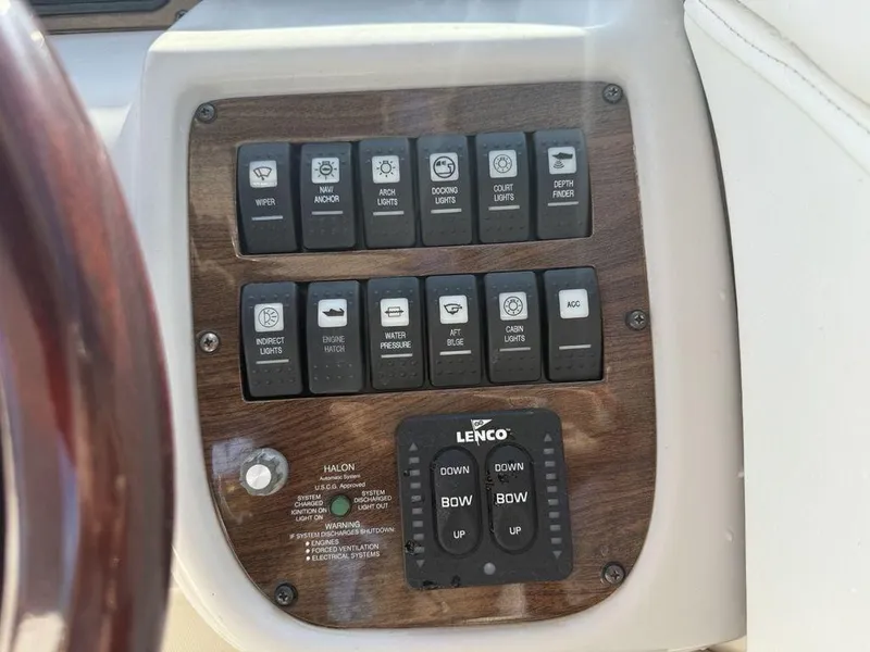 Slide: The Image of Control panel of a 2007 Chaparral 276 SSX boat with various switches and Lenco trim tab controls. - 25