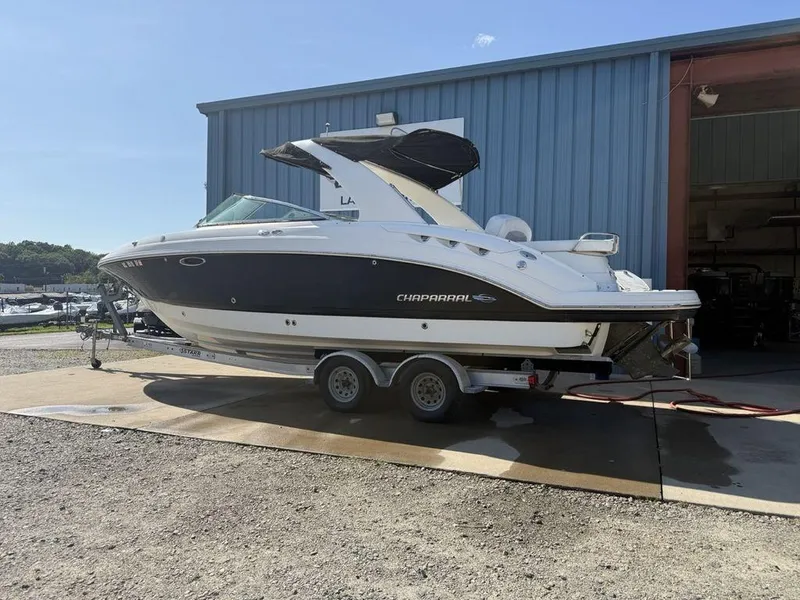 Slide: The Image of 2007 Chaparral 276 SSX boat on trailer outside a blue storage building. - 4