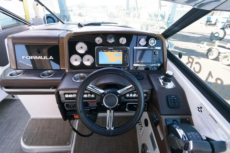 Slide: The Image of 2016 Formula 330 Crossover Bowrider dashboard with steering wheel and navigation controls. - 12