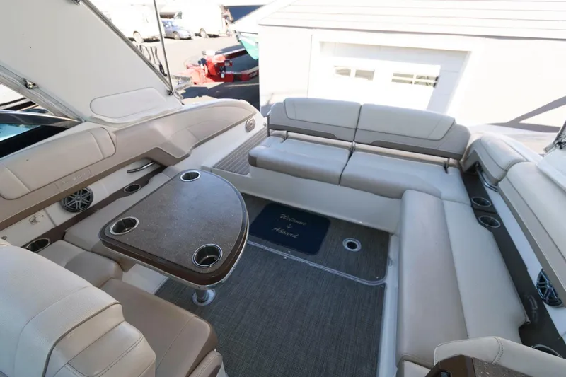 Slide: The Image of 2016 Formula 330 Crossover Bowrider interior with spacious seating and table. - 16