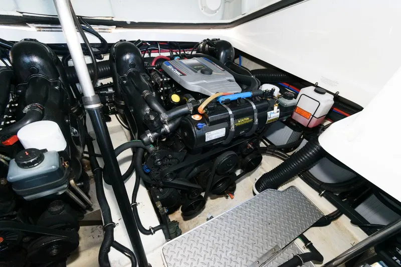 Slide: The Image of Engine compartment of a 2016 Formula 330 Crossover Bowrider boat, showcasing dual engines. - 23