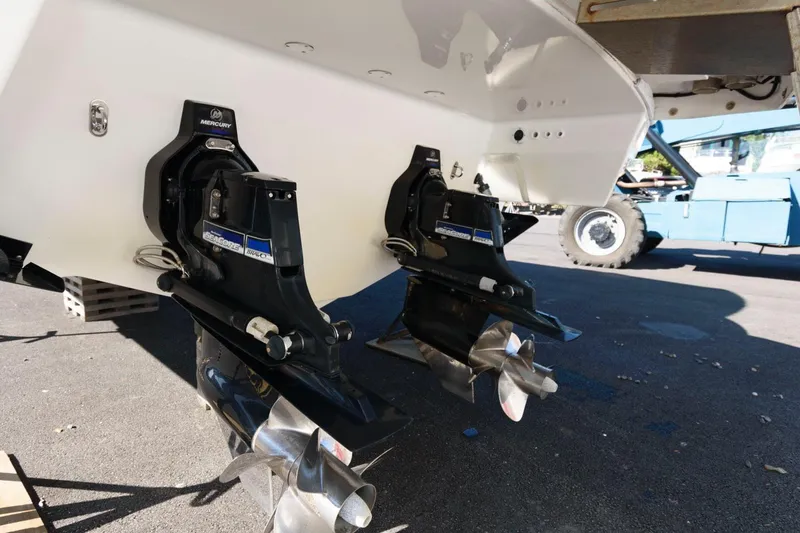 Slide: The Image of 2016 Formula 330 Crossover Bowrider with dual outboard motors, parked on pavement. - 25