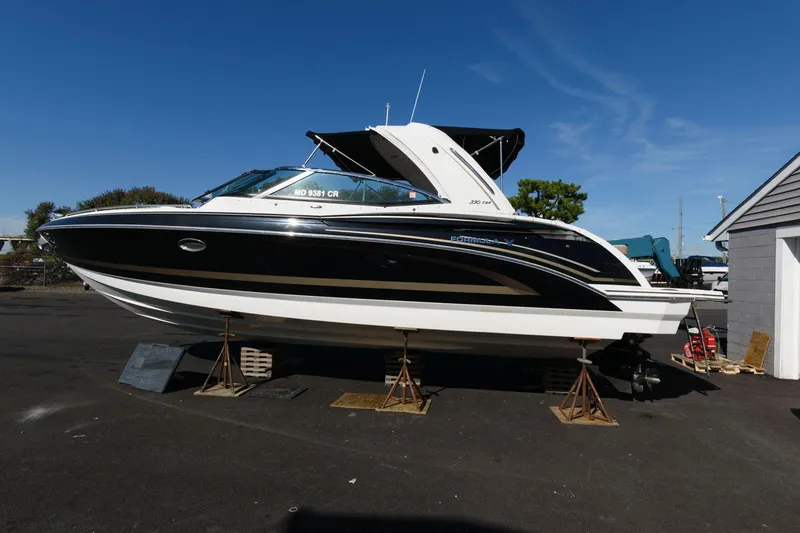 Slide: The Image of 2016 Formula 330 Crossover Bowrider on stands, black and white design, outdoor setting. - 4