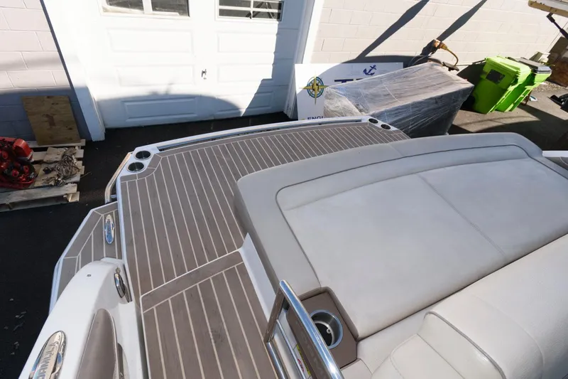 Slide: The Image of 2016 Formula 330 Crossover Bowrider boat deck with cushioned seating and sleek design. - 7
