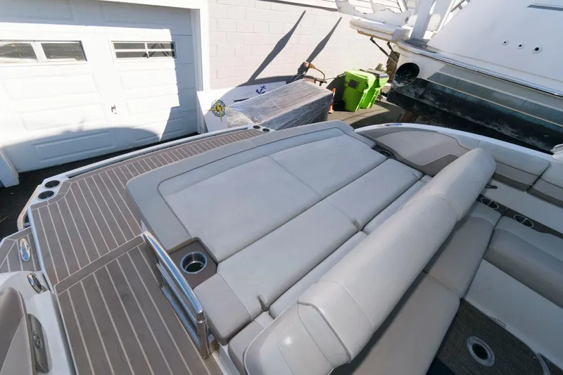 Slide: The Image of 2016 Formula 330 Crossover Bowrider with spacious seating and sleek design in a marina setting. - 8