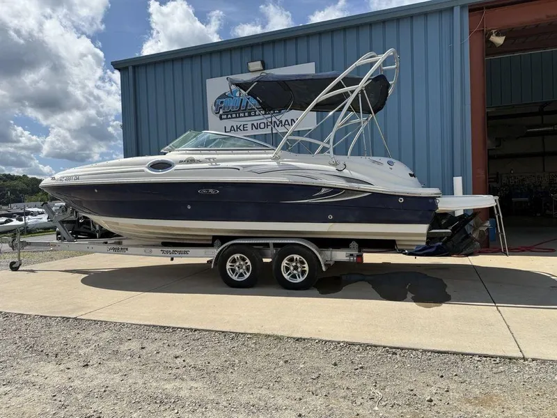 The Image of 2005 Sea Ray 240 Sundeck boat on trailer outside marine center. - 0