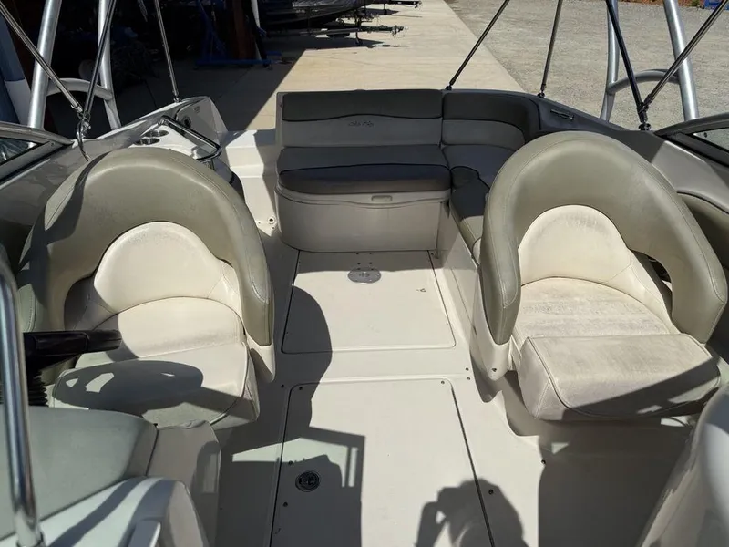 Slide: The Image of 2005 Sea Ray 240 Sundeck interior with seating and open deck layout. - 12