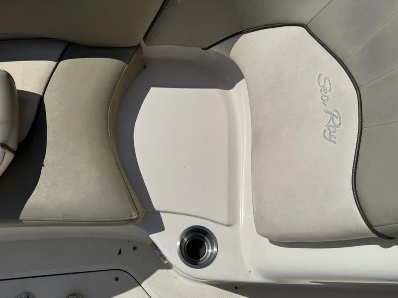 Slide: The Image of 2005 Sea Ray 240 Sundeck boat interior with seating and cup holder. - 15