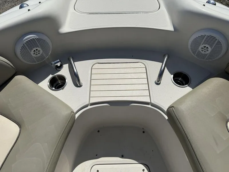 Slide: The Image of Interior of a 2005 Sea Ray 240 Sundeck boat with cup holders and speakers. - 2