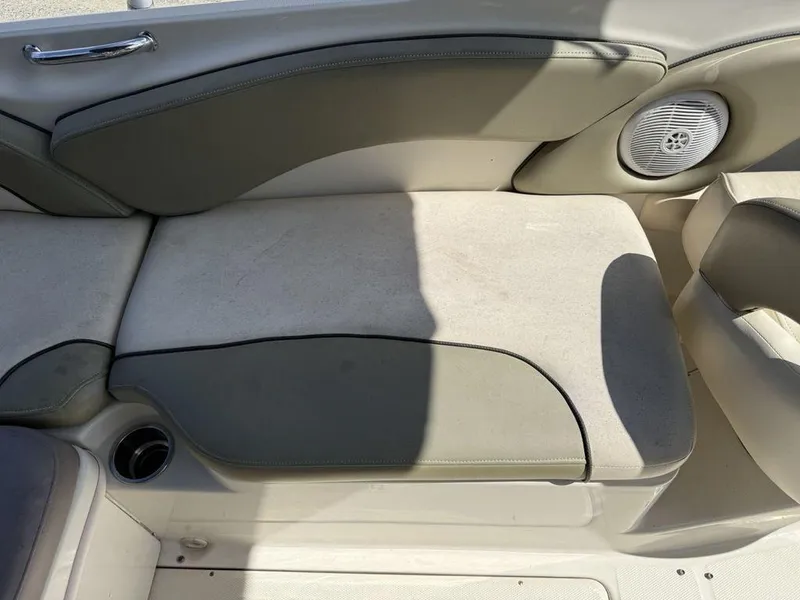 Slide: The Image of 2005 Sea Ray 240 Sundeck interior seating with speaker and cup holder. - 20