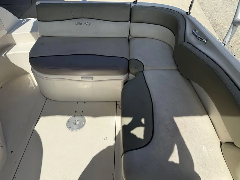 Slide: The Image of 2005 Sea Ray 240 Sundeck interior seating with gray and white upholstery. - 21