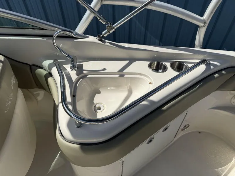 Slide: The Image of 2005 Sea Ray 240 Sundeck boat sink and cup holders in cockpit area. - 30