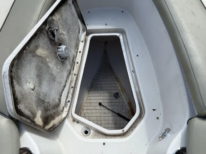 Slide: The Image of Open storage compartment on a 2005 Sea Ray 240 Sundeck boat. - 32