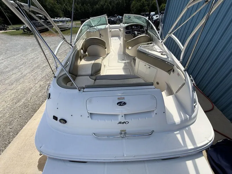 Slide: The Image of 2005 Sea Ray 240 Sundeck boat with spacious seating and sleek design, docked outdoors. - 33