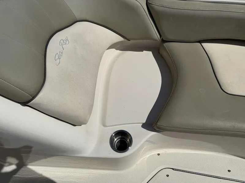 Slide: The Image of 2005 Sea Ray 240 Sundeck boat seating area with logo and cup holder. - 35