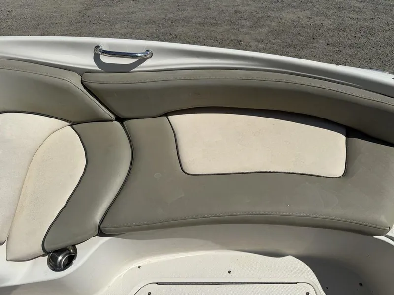 Slide: The Image of 2005 Sea Ray 240 Sundeck boat seating with beige and gray cushions. - 4