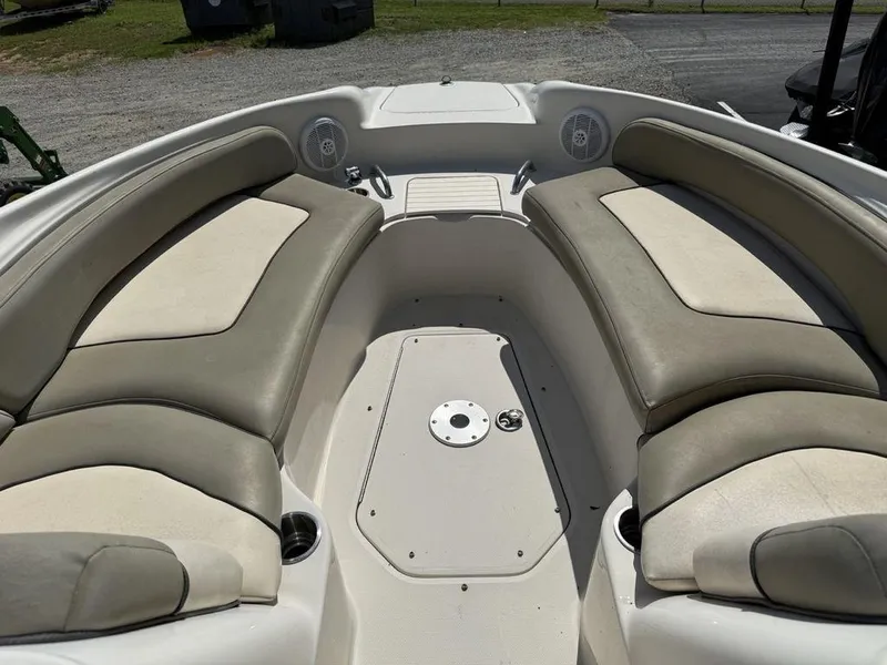 Slide: The Image of 2005 Sea Ray 240 Sundeck interior with cushioned seating and cup holders. - 5