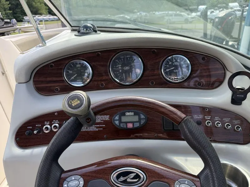 Slide: The Image of Dashboard of a 2005 Sea Ray 240 Sundeck boat with gauges and controls. - 9