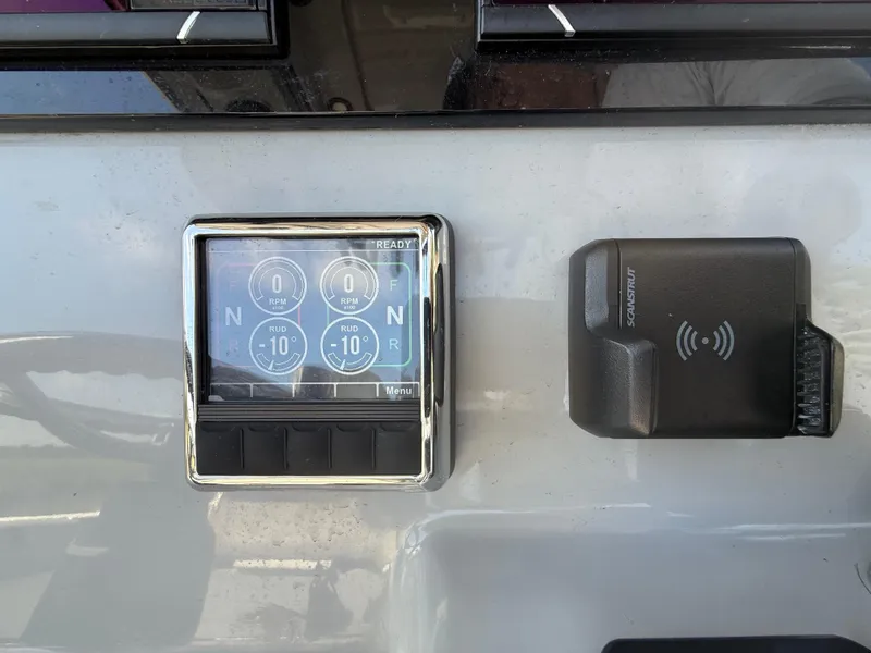 Slide: The Image of 2024 Sea Pro 262DLX dashboard with control panel and wireless charging pad. - 11