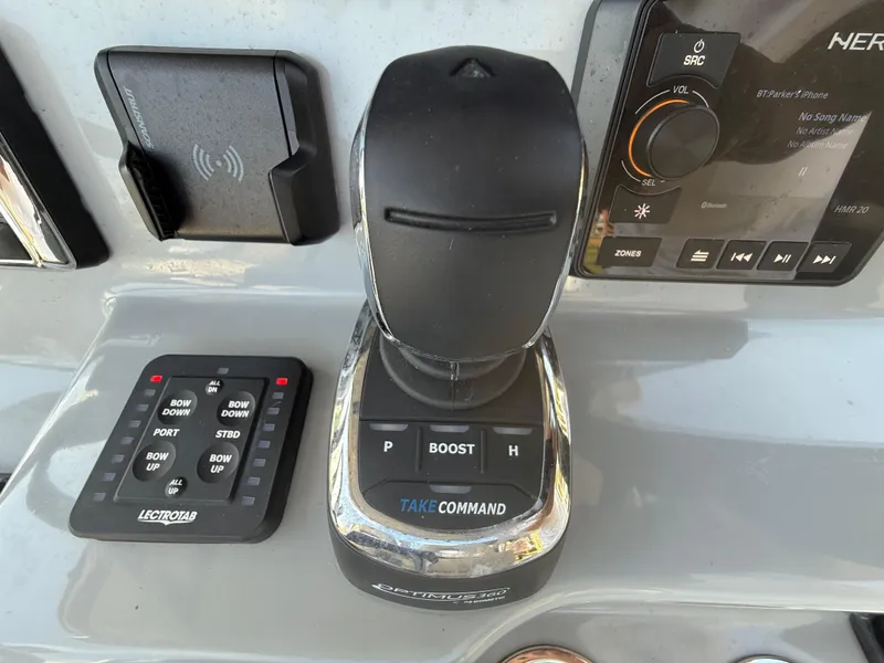 Slide: The Image of 2024 Sea Pro 262DLX boat control panel with joystick and audio system. - 12