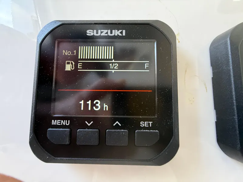 Slide: The Image of Suzuki digital gauge displaying fuel level and 113 hours on a 2024 Sea Pro 262DLX boat. - 14