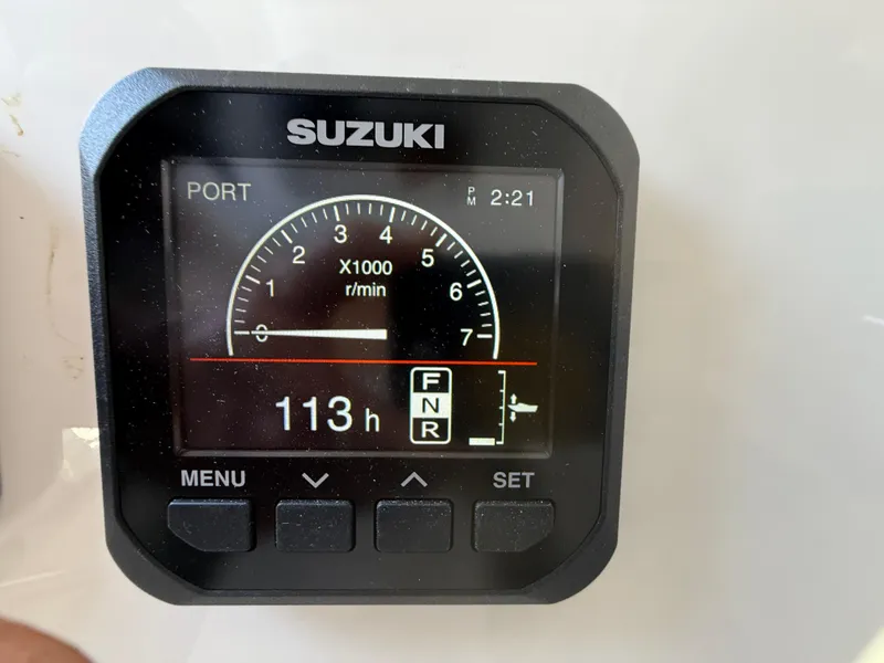 Slide: The Image of Suzuki engine display on 2024 Sea Pro 262DLX, showing 113 hours and RPM gauge. - 15