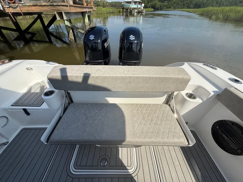 Slide: The Image of 2024 Sea Pro 262DLX boat with dual Suzuki engines, featuring a foldable rear bench seat. - 32