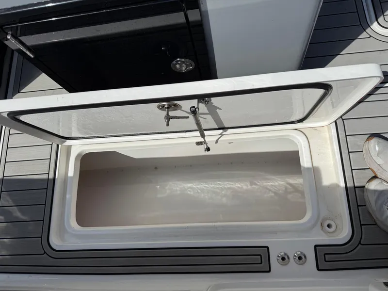 Slide: The Image of Open storage compartment on 2024 Sea Pro 262DLX boat deck. - 37