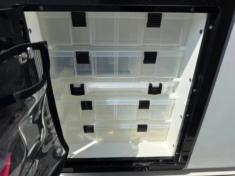 Slide: The Image of Storage compartment with clear plastic drawers on a 2024 Sea Pro 262DLX boat. - 40