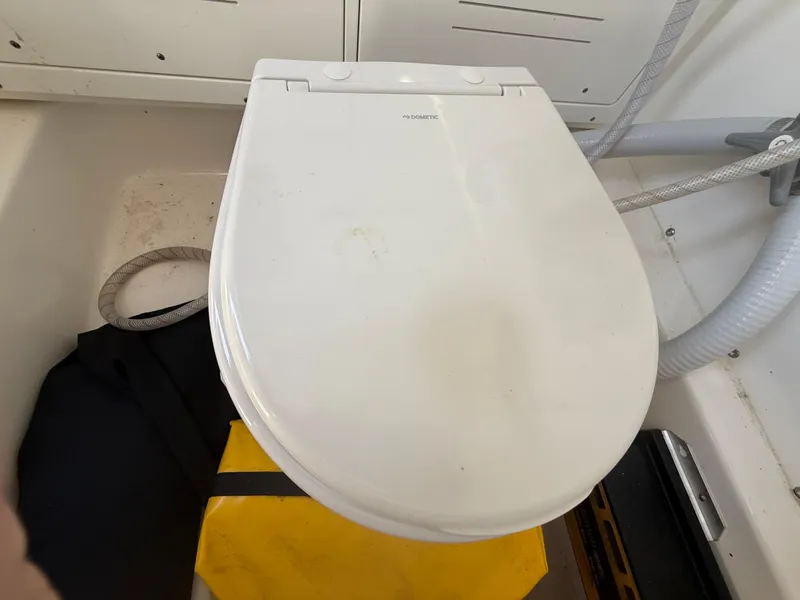 Slide: The Image of 2024 Sea Pro 262DLX boat toilet with white seat and surrounding equipment. - 41
