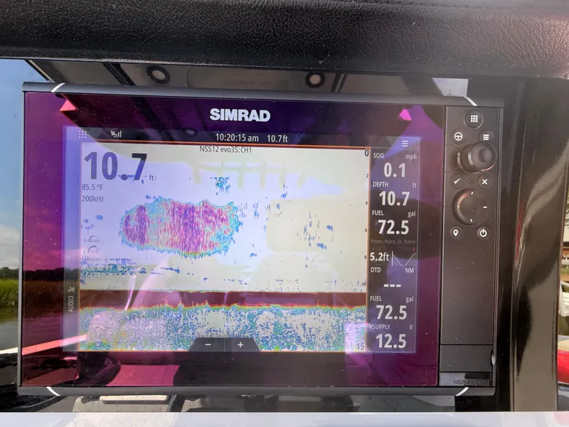 Slide: The Image of Simrad fishfinder display on 2024 Sea Pro 262DLX boat, showing depth and sonar data. - 8