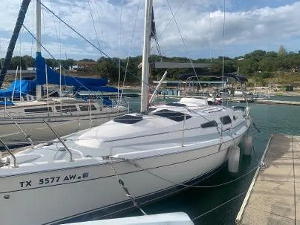 The Image of 2008 Hunter 33 sailboat docked at marina, clear sky, calm water. - 1