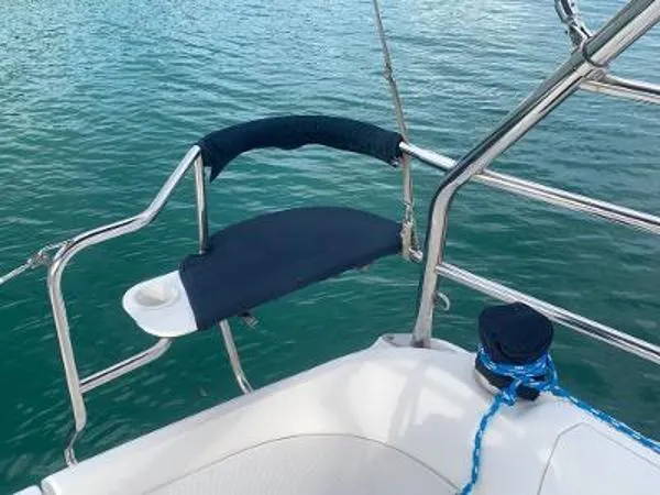 Slide: The Image of Sailboat deck with cushioned seat, Hunter 33 model, 2008, overlooking calm water. - 11