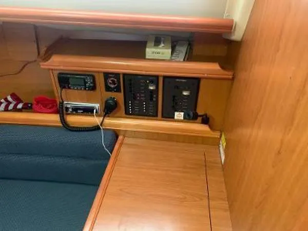 Slide: The Image of 2008 Hunter 33 yacht interior with control panel and seating area. - 14