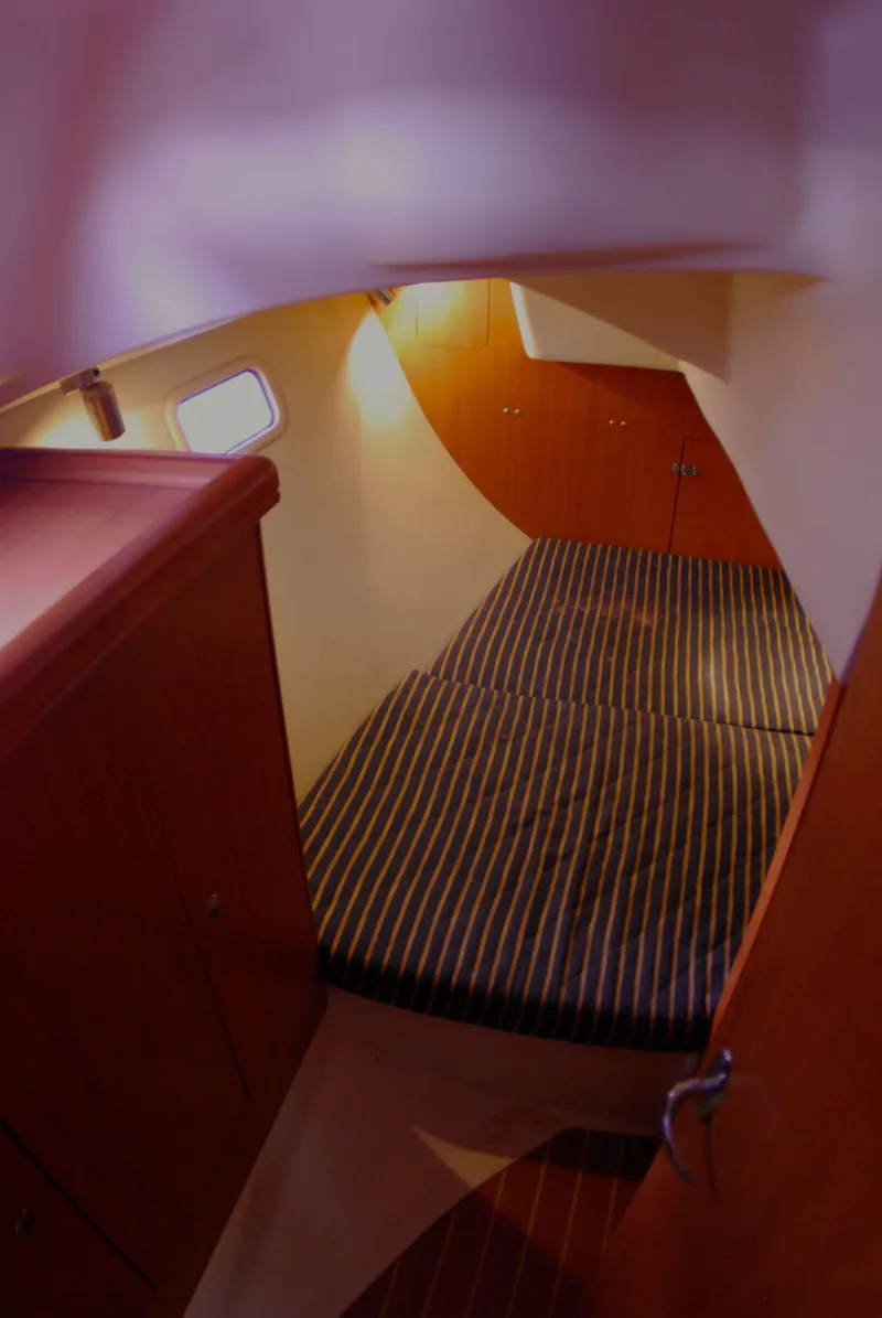 Slide: The Image of Interior cabin of a 2008 Hunter 33 sailboat with striped bedding. - 19