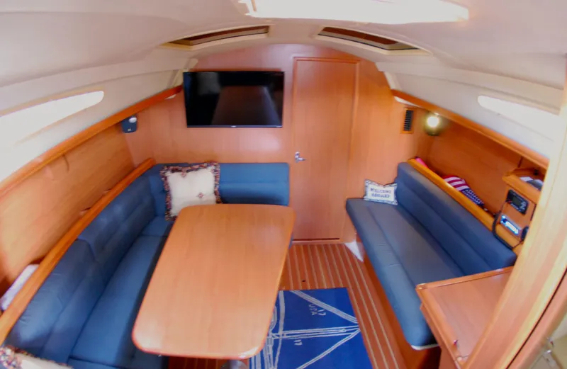Slide: The Image of Interior of 2008 Hunter 33 sailboat with cozy seating and wooden table. - 22