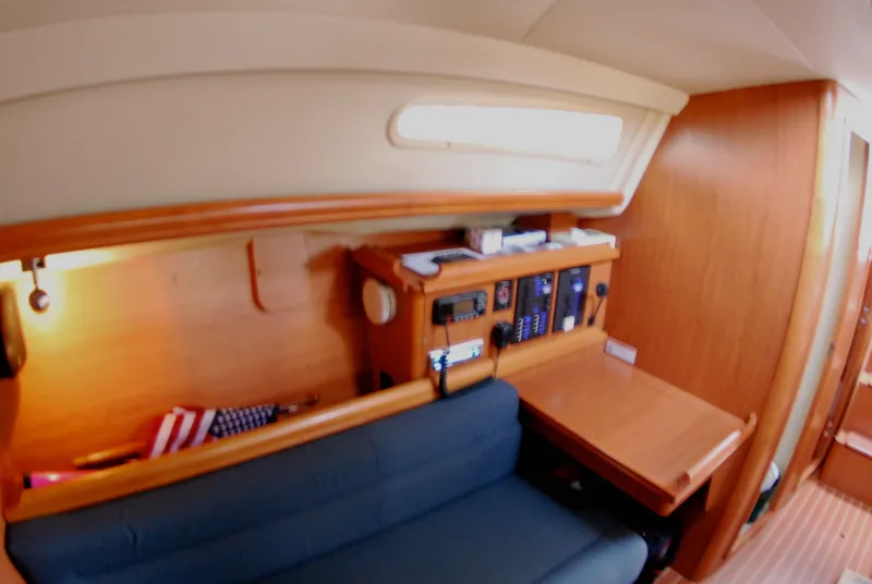 Slide: The Image of Interior of 2008 Hunter 33 sailboat with navigation station and seating area. - 23