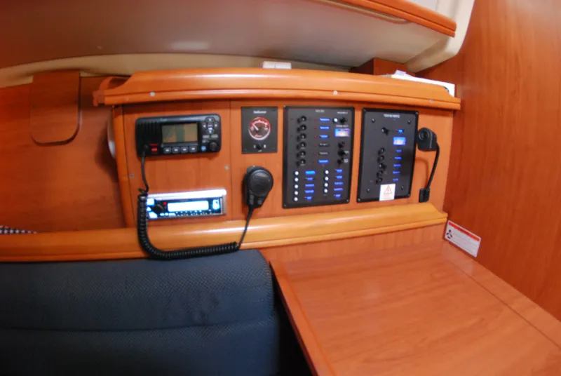 Slide: The Image of Control panel inside a 2008 Hunter 33 sailboat, featuring navigation and communication equipment. - 24