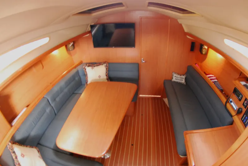 Slide: The Image of Interior of a 2008 Hunter 33 sailboat with cozy seating and wooden finishes. - 29