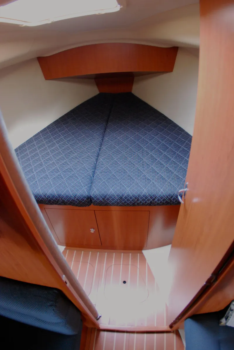 Slide: The Image of 2008 Hunter 33 sailboat cabin with V-berth and wooden interior. - 31