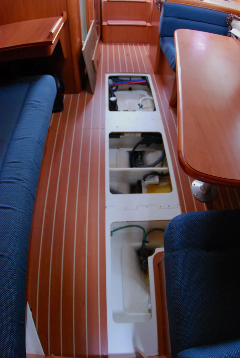 Slide: The Image of Interior of 2008 Hunter 33 sailboat showing open floor compartments and seating area. - 34