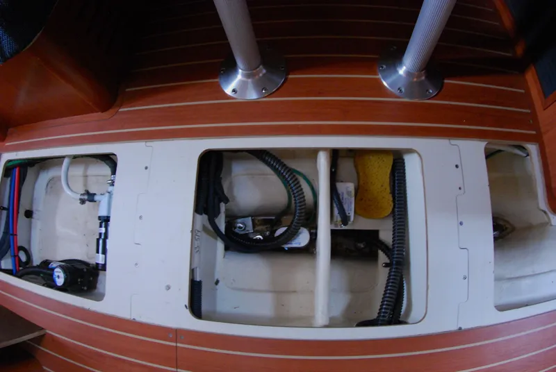 Slide: The Image of Interior view of a 2008 Hunter 33 sailboat showing underfloor compartments and equipment. - 35