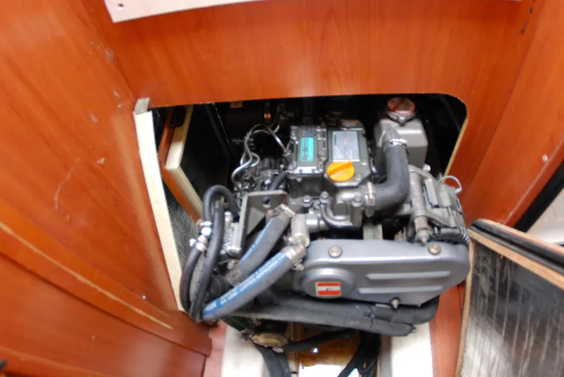 Slide: The Image of Engine compartment of a 2008 Hunter 33 sailboat, showcasing mechanical components and hoses. - 39