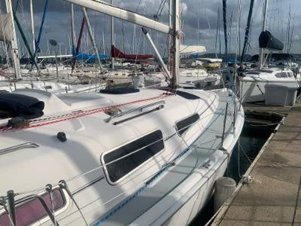 Slide: The Image of 2008 Hunter 33 sailboat docked in a marina, surrounded by other boats. - 4