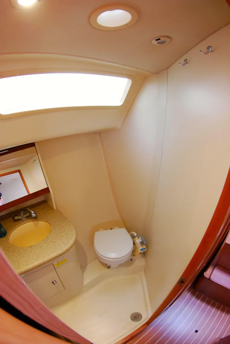 Slide: The Image of 2008 Hunter 33 yacht bathroom with sink, toilet, and overhead lighting. - 40