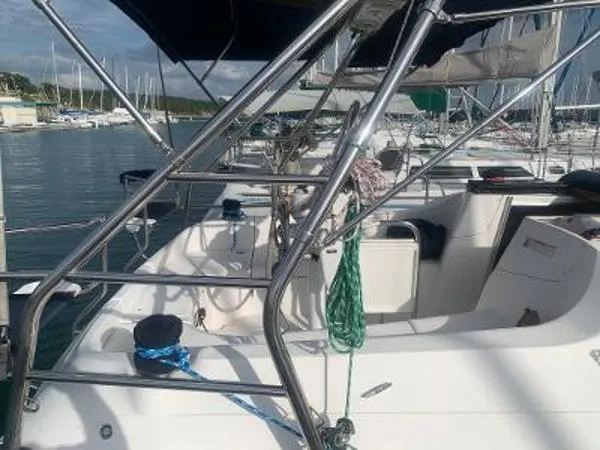 Slide: The Image of 2008 Hunter 33 sailboat deck with stainless steel railings in a marina setting. - 8