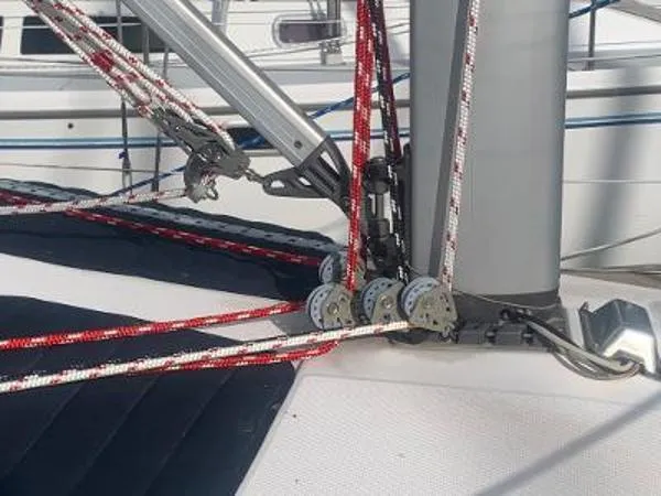 Slide: The Image of Rope rigging on a 2008 Hunter 33 sailboat deck, featuring pulleys and mast. - 9