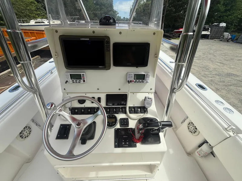 Slide: The Image of Center console of a 2002 Contender 27 Tournament boat with navigation equipment and steering wheel. - 1