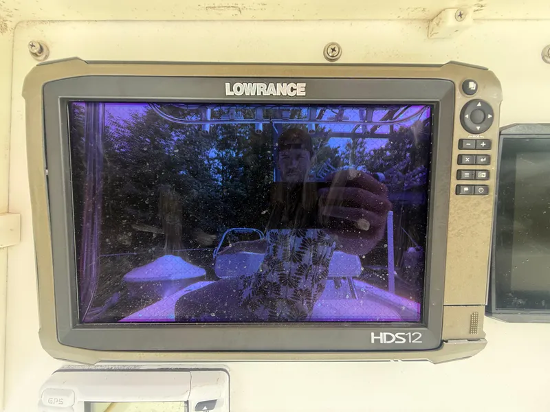 Slide: The Image of Lowrance HDS12 display on 2002 Contender 27 Tournament boat, reflecting surroundings. - 13