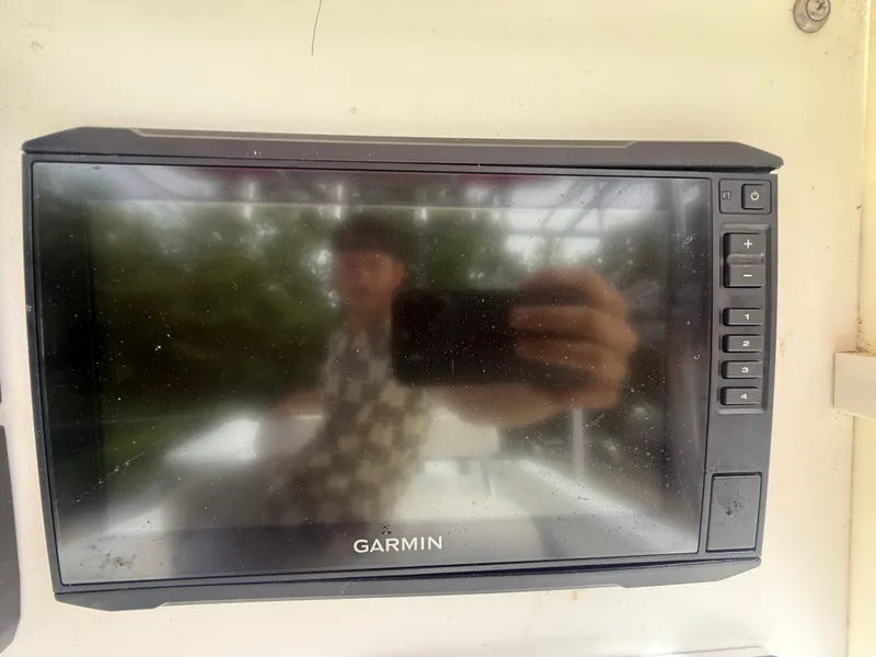 Slide: The Image of Garmin marine display on a 2002 Contender 27 Tournament boat dashboard. - 14
